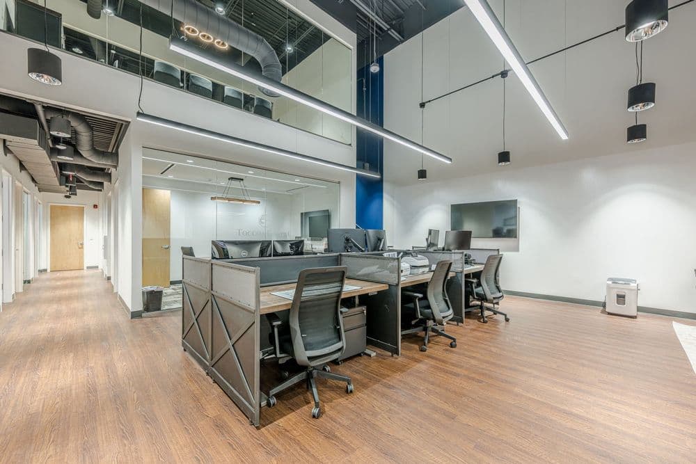 Modern office interior featuring collaborative workspaces and sleek design.